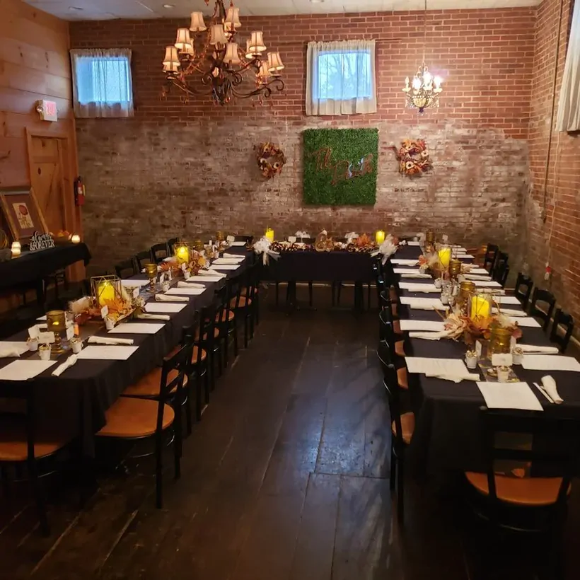 Long banquet tables decorated for an autumn celebration at The Attic Restaurant